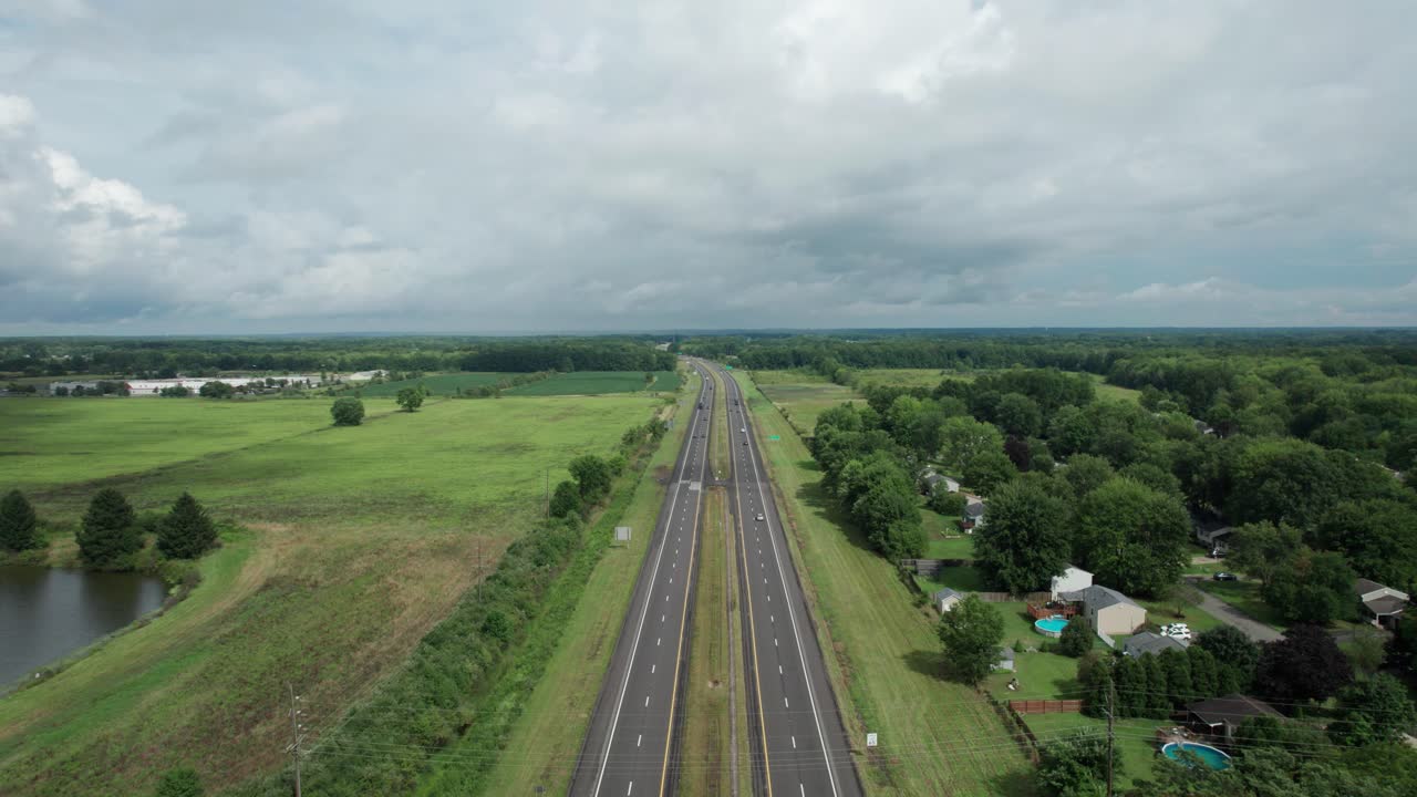 오하이오 주 회색 흐린 하늘 아래 두 개의 놀라운 호수가 있는 긴 도로 위를 날고 있습니다.