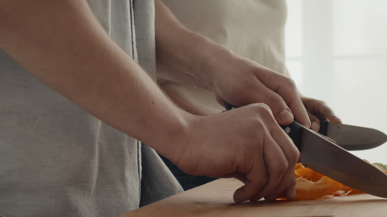 Couple chopping vegetables