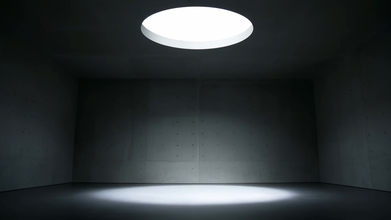 Dark Concrete Room Illuminated By Skylight, Single Round Skylight Casting Focused Circular Beam On Floor,