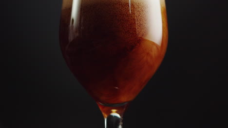 pouring a drink into a glass
