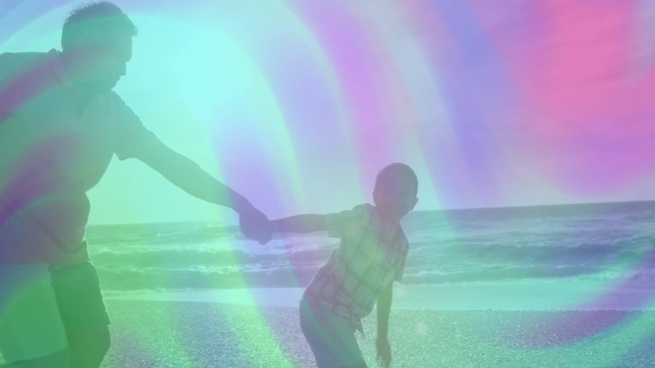 Senior man grabbing child's hand at shoreline with waves and guiding playful run for health theme
