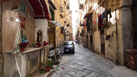 car driving through a narrow, historic street