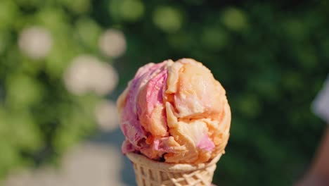 melting multicolored ice cream drips from a crispy waffle cone, creating a refreshing and delightful treat on a bright summer day, perfect for enjoying outdoors