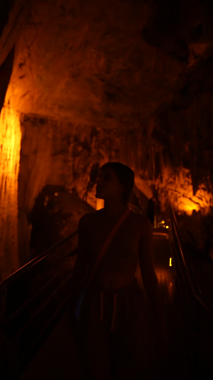 Woman Exploring a Cave