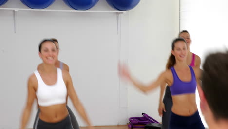 aerobics instructor leading a happy class of women