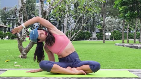 woman practicing yoga in a park