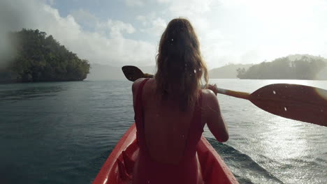 woman kayaking in tropical waters