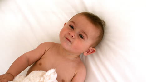 Cute-baby-on-a-bed-with-teddy-bear