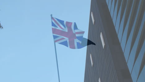 union jack flag waving animation over modern building and tree