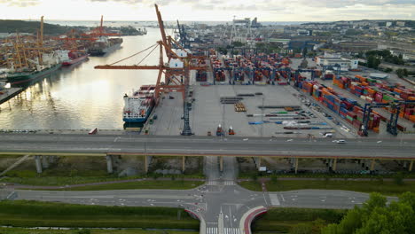 cars driving across road bridge over intersection near shipyard harbour in port of gdynia, poland