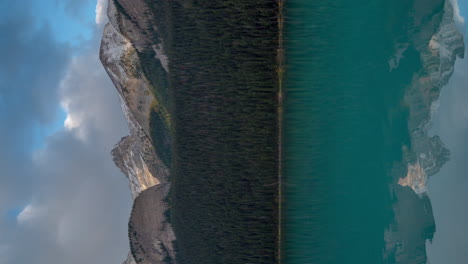 Vertical-4k-Time-Lapse,-Blue-Glacial-Water-and-Dramatic-Clouds-Above-Snow-Capped-Mountain-Peaks