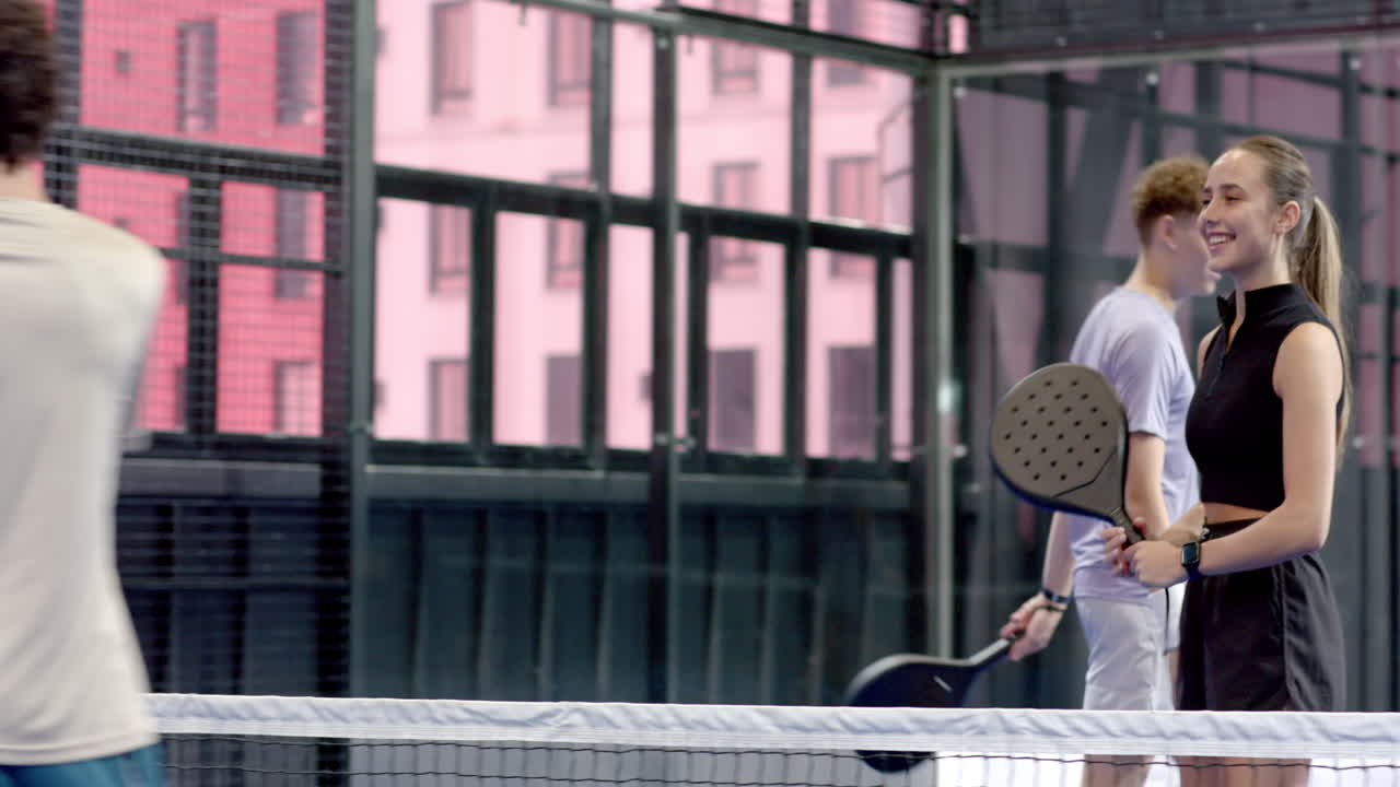 Playing padel tennis, man preparing to serve on indoor court