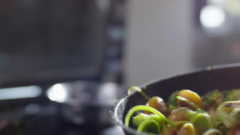 tossing food on skillet