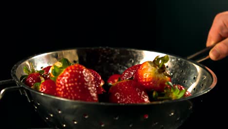 Water-drops-on-strawberries-in-a-sieve