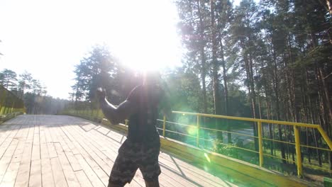 man celebrating outdoors in a forest