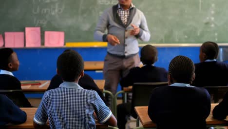 male teacher teaching students in the classroom 4k