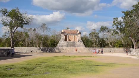 tourists visiting temple of the bearded man or the north temple in the great ball court, chichen itza archaeological site