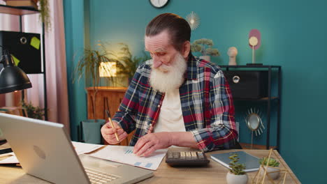 tired exhausted senior man freelancer analyzing paperwork graphs accounting payments bank bills