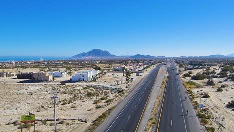 view of a drone flying back and descending over a highway