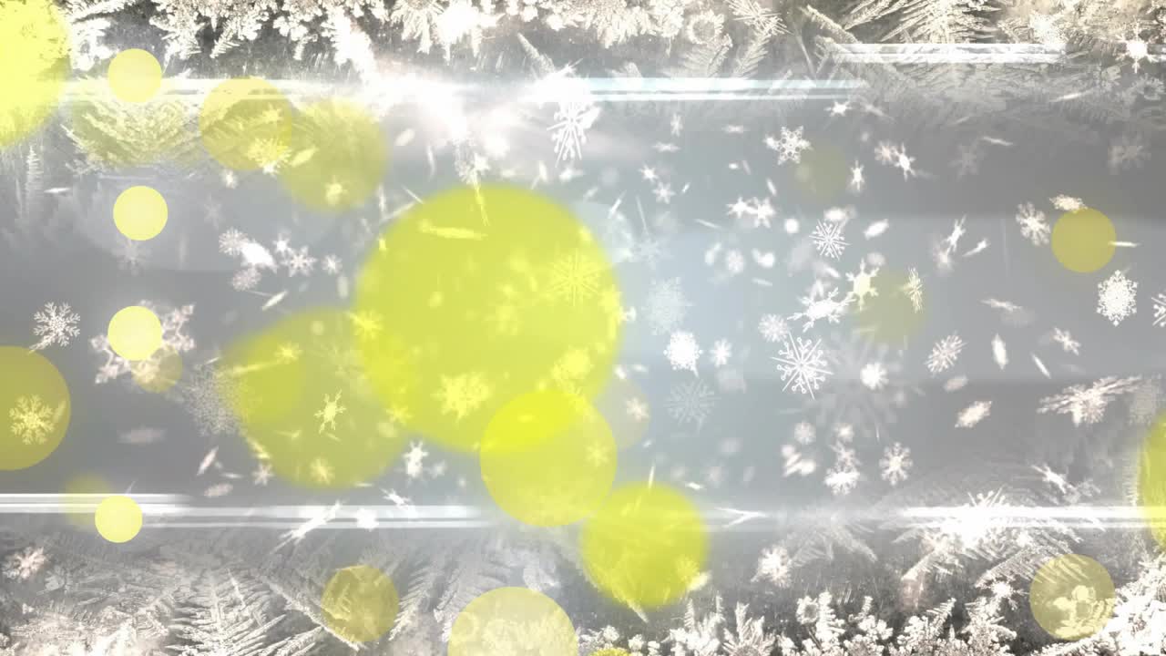 First flake drift causing yellow bokeh fading in and overlapping, forming layered winter backdrop