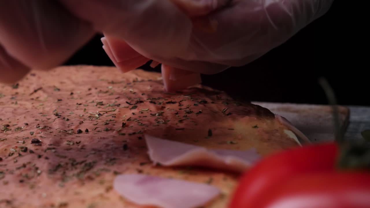 Chef preparing a ham pizza