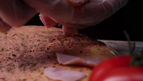 chef preparing a ham pizza