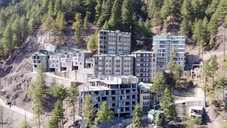 modern residential buildings nestled in a forested mountain area, showcasing architectural integration with nature