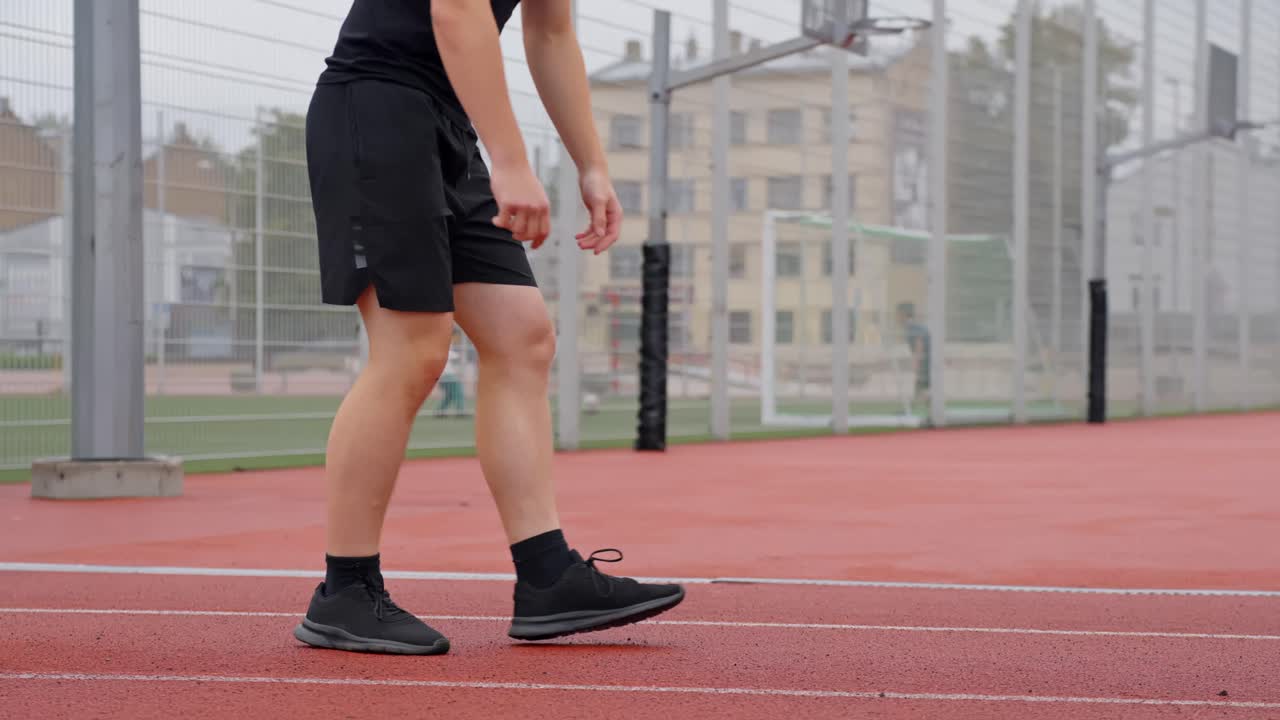 Athletic white male braces hands on ground preparing to sprint from running start position