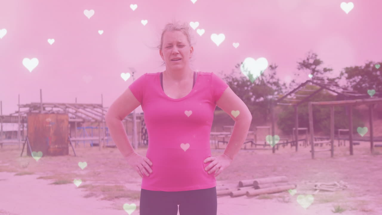 Woman in pink shirt standing outdoors with heart animation overlay