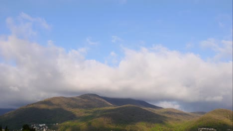 blue sky white clouds over the mountains. puffy fluffy white clouds. cumulus cloud scape timelapse. summer blue sky time lapse. dramatic majestic amazing blue sky. soft white clouds form. clouds time lapse background