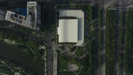 top down aerial view of ultra modern lakeside housing and apartment development on a sunny day with park, green space, bridges and new architecture