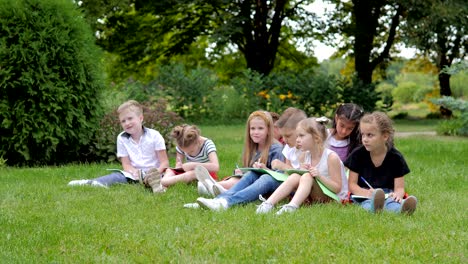 group of cheerful children learning outdoors at school after quarantine lockdown