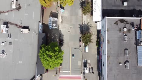 aerial birds eye view fly over downtown vancouver gay pride village the west end where iconic lgbtq flag paved on intersection of davie and bute on a sunny afternoon with modern portable bathroom 2-4