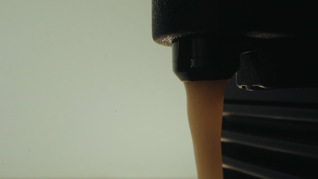 Freshly brewed coffee dripping from an espresso machine, rich and aromatic