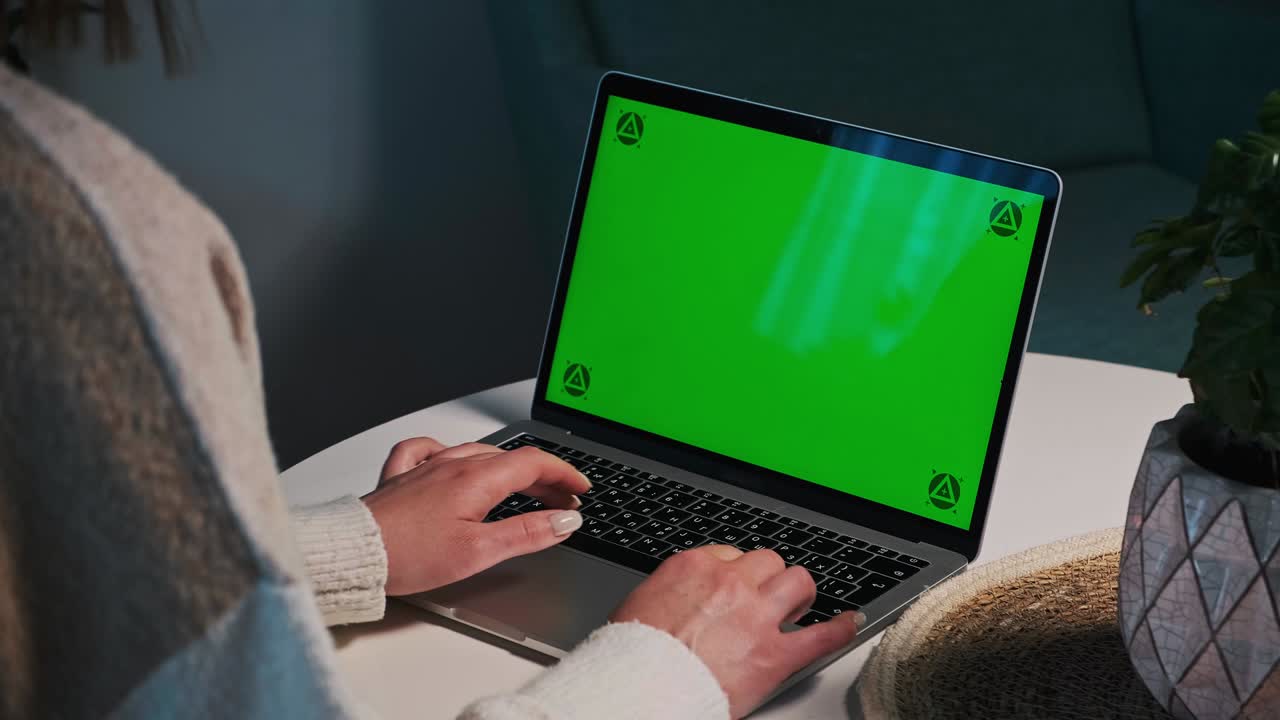 Woman hands Using typing Chroma key green screen laptop computer on desk at home. Track points