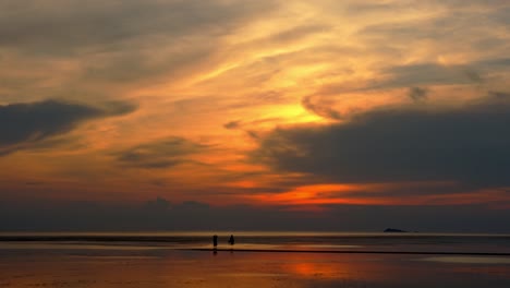 sunset at the beach with silhouettes