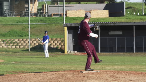 two teams of male baseball players playing baseball, throwing the ball on a pitch, slow motion
