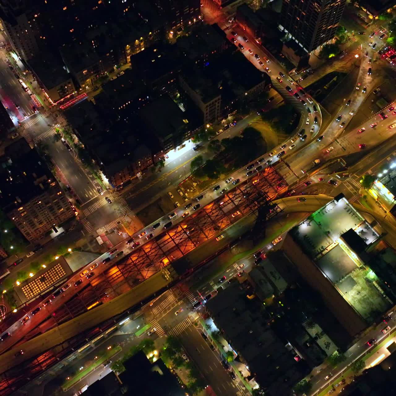 Neversleeping New York at night. Busy traffic along light roads of metropolis from aerial perspective