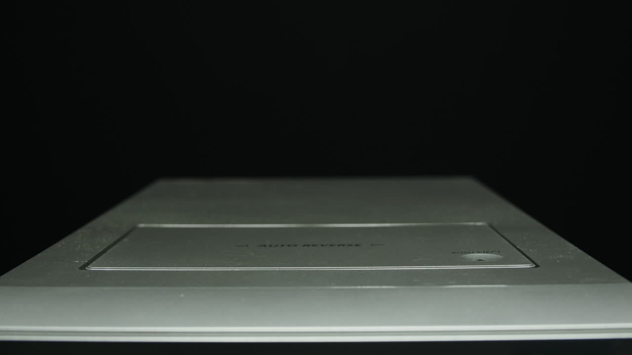 Cassette tape player, Close-up of a spinning vintage audio cassette in tape recorder. Retro magnetic cassette plays music. selective focus, shallow depth of field