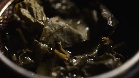 large-leaf green tea in a kettle rotates on a stand. tea ceremony