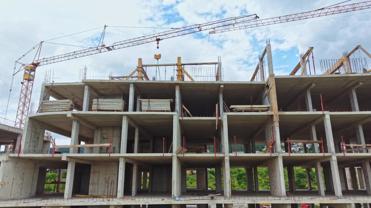 Ongoing building project. Multilevel concrete structure under active development scene. Urban construction site showcasing steel framework and crane activity in progress