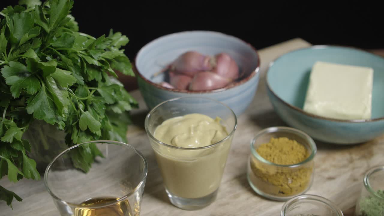 Top view dolly shot of lined up ingredients for the legendary caf&eacute;-de-paris sauce