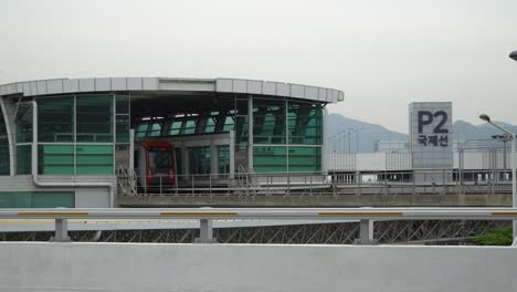 light rail transit entering station at gimhae international airport in busan, korea