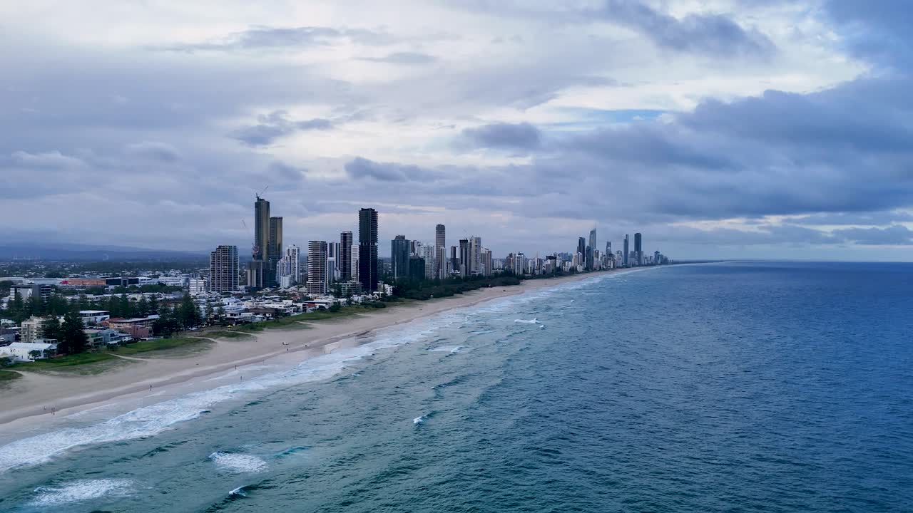 바다와 도시 스카이라인 위의 해가 지는 모습