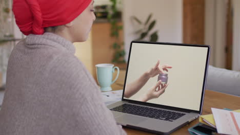 biracial woman using laptop, online shopping for beauty products, slow motion