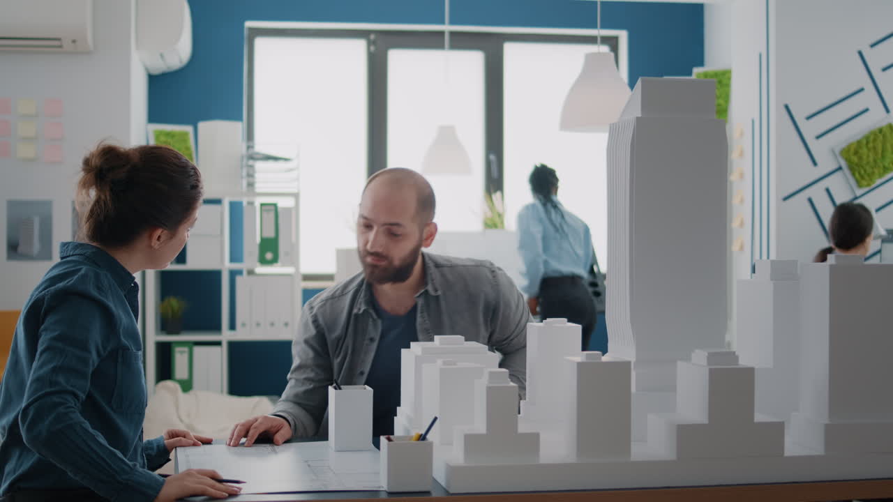 Architects Collaborating on Building Model in Office