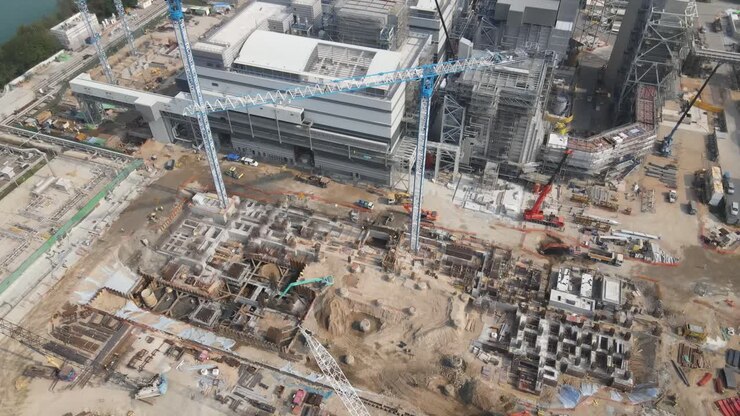 Cranes Lifting Heavy Materials In Construction Of Power Station
