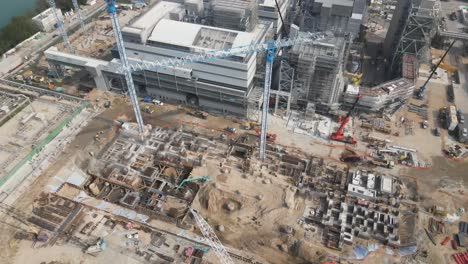 cranes lifting heavy materials in construction of power station