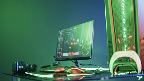 video of gaming computer and gaming equipment on desk with copy space on neon background