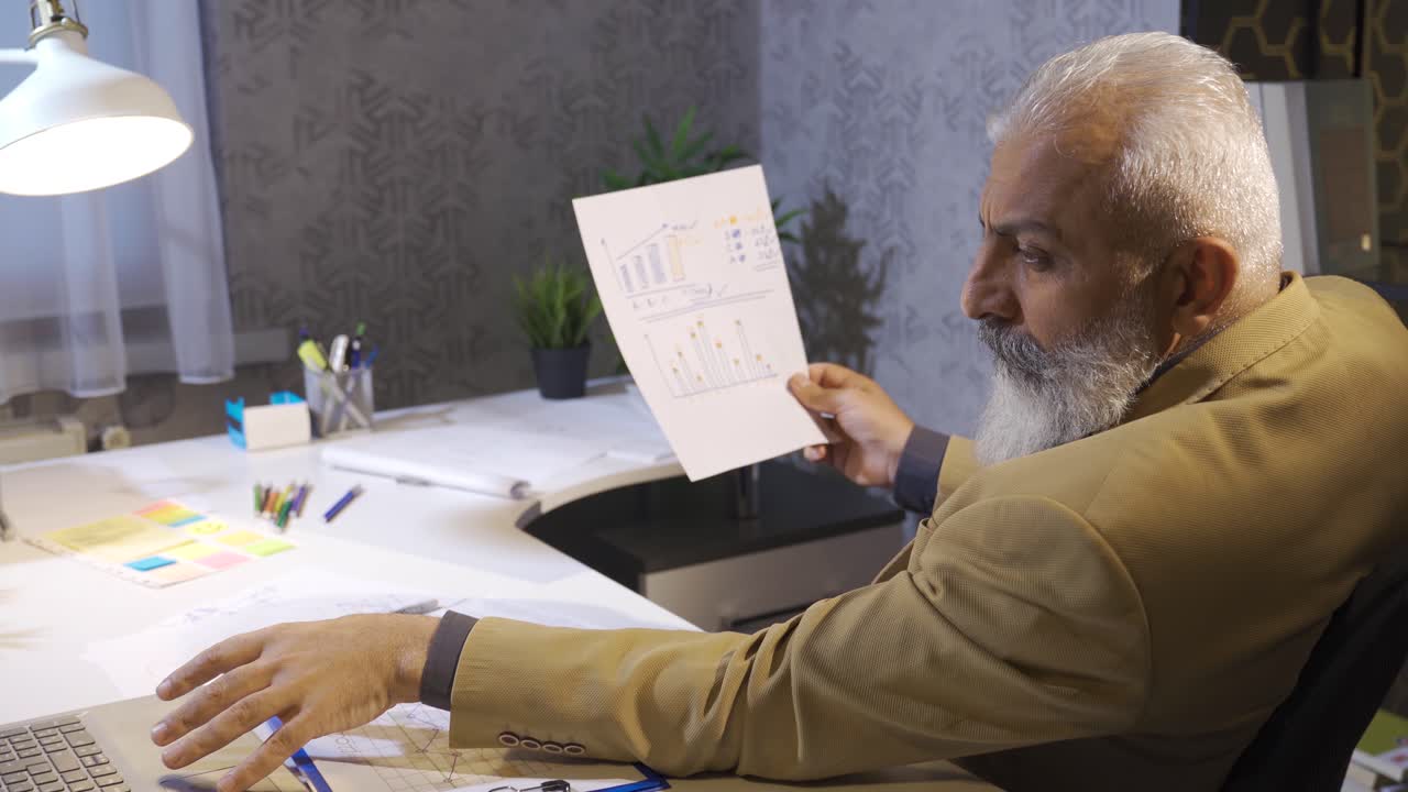 Boss examines company business chart.